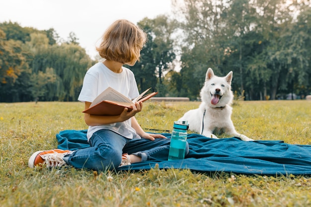 Little girl with white dog Husky in the park