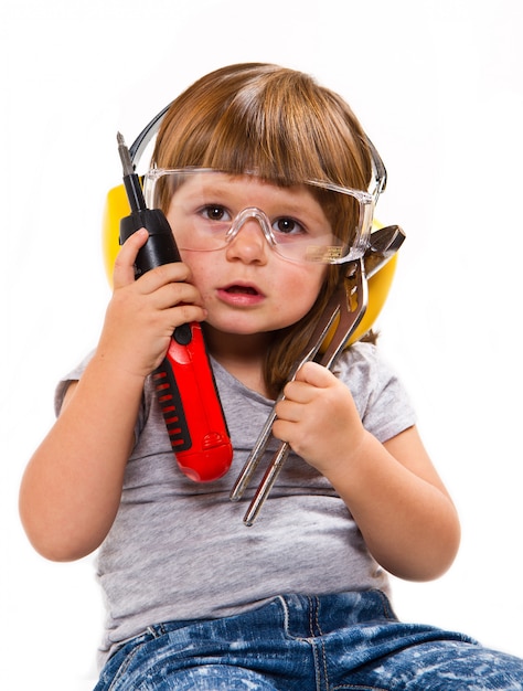 little girl with work tools and screwdriver