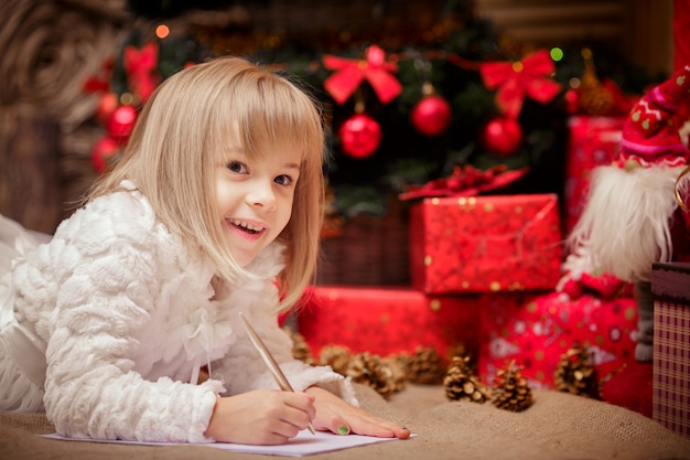 Little girl writes a letter to Santa Claus