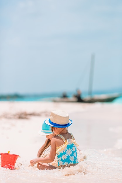 Little girls on the beach during summer vacation