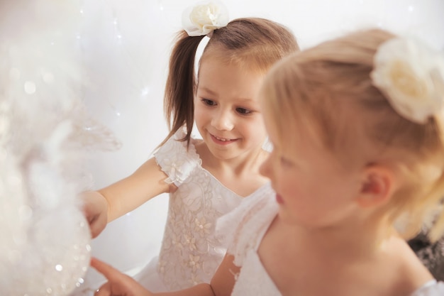 Little girls decorating christmas tree