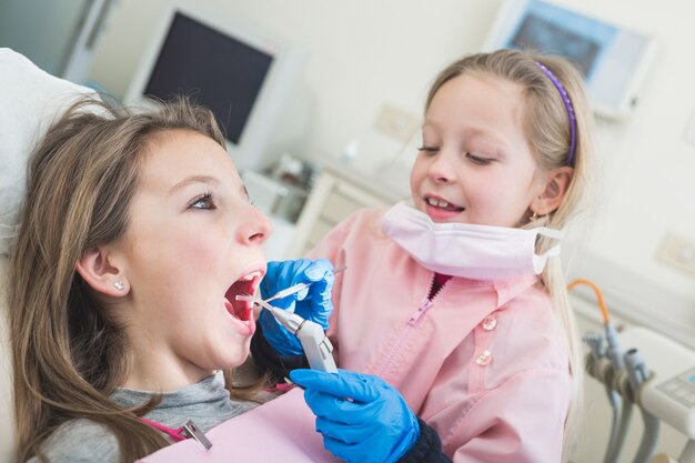 Little Girls Dentist and Patient During Dental Examination.