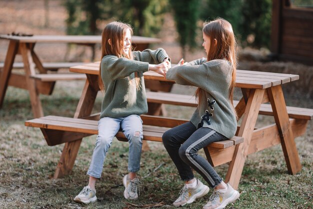 Little girls in outdoor park on her weekend