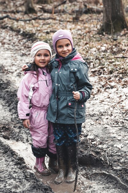 Little girls play in the swamp. Two little sisters. Friendship and love. A family