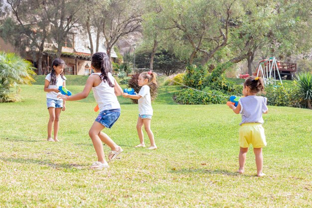 Little girls playing with water in the summer