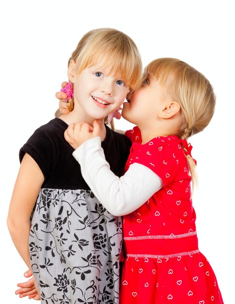 Little girls sharing a secret