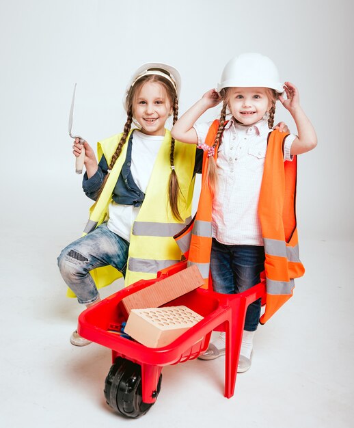 Little girls on the white scenery. Construction