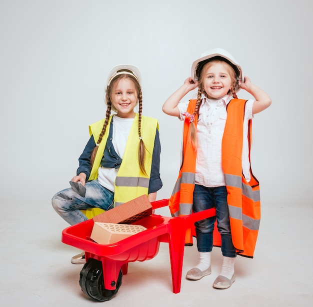 Little girls on the white scenery. Construction