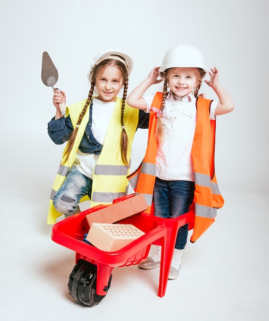 Little girls on the white scenery. Construction