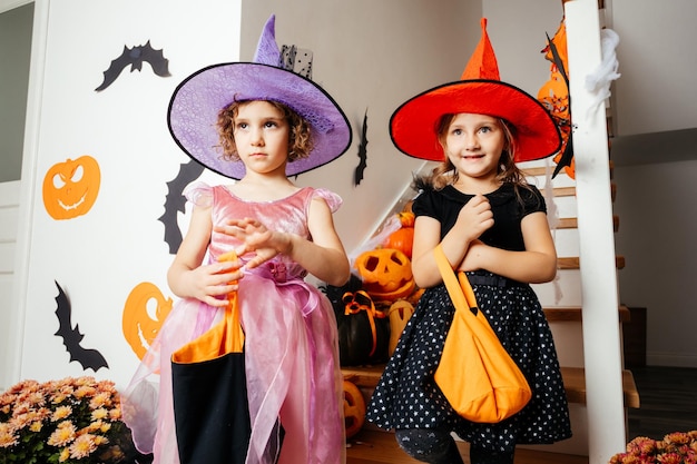 Little girls witches waiting for halloween treats