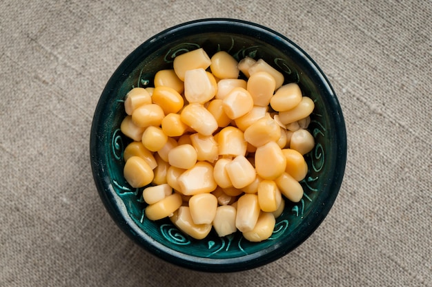 A little green bowl with preserved sweet corn