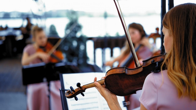 little group of violinists on the terrace