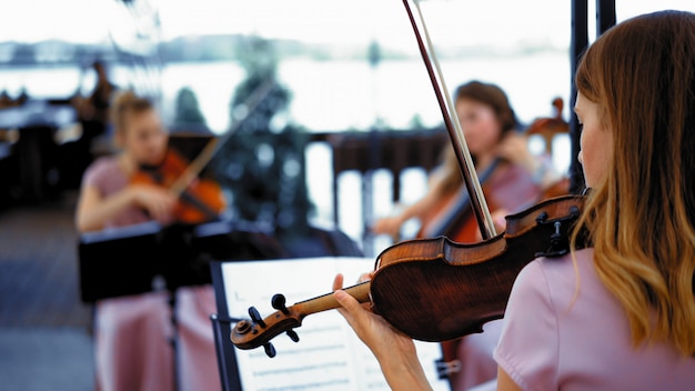 Little Group Of Violinists On The Terrace