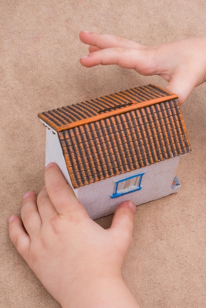 Little hand and a model house