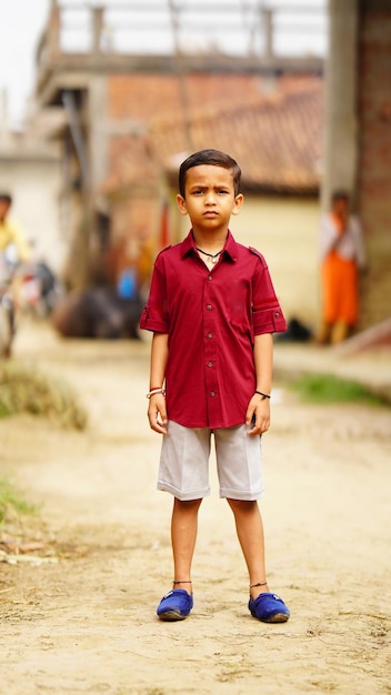 Little handsome boy in village