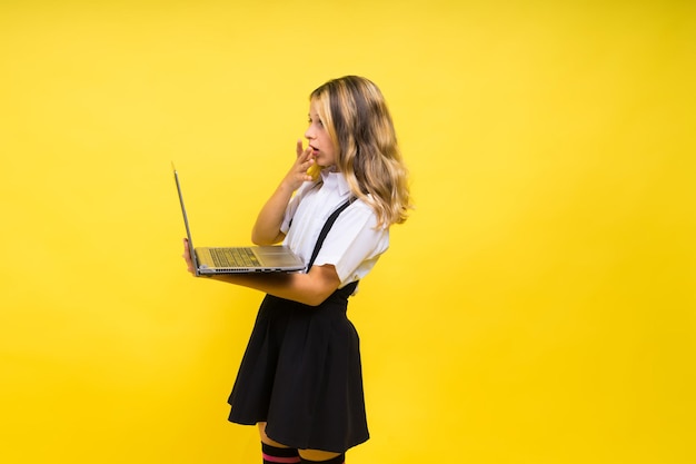 Little happy blonde kid girl 1213 years laptop pc computer Children lifestyle childhood concept