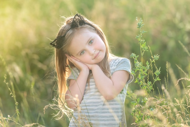 Little happy girl at sunset