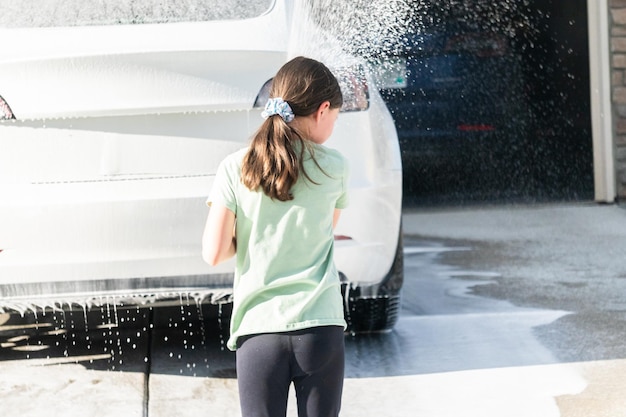 Little helper washing the family electric car