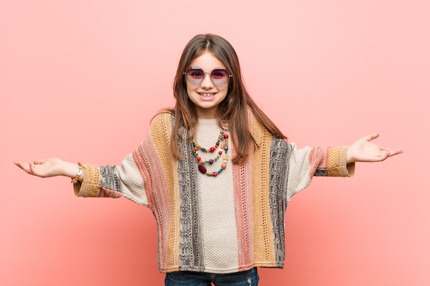 Little hippie girl showing a welcome expression.