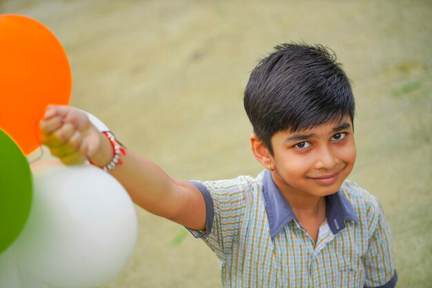 Little indian boy with tricolor balloons