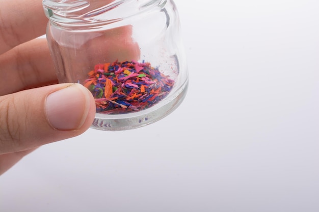 Little jar filled with color powder in hand