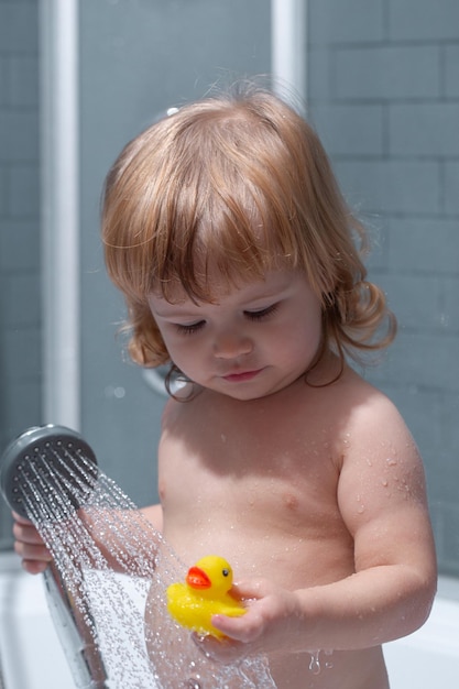 Little kid bathing in soapsuds little baby child is washing her hair in bath