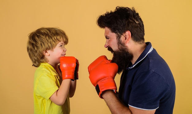 Photo little kid boxer with coach at boxing training child with boxing trainer ready to sparring boy and