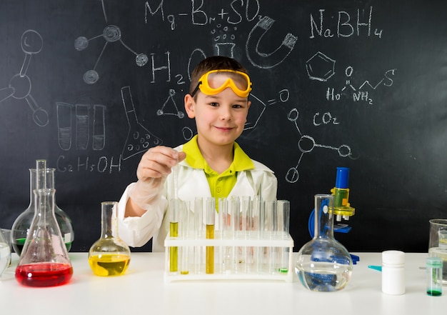 Little kid on chemistry lesson in lab