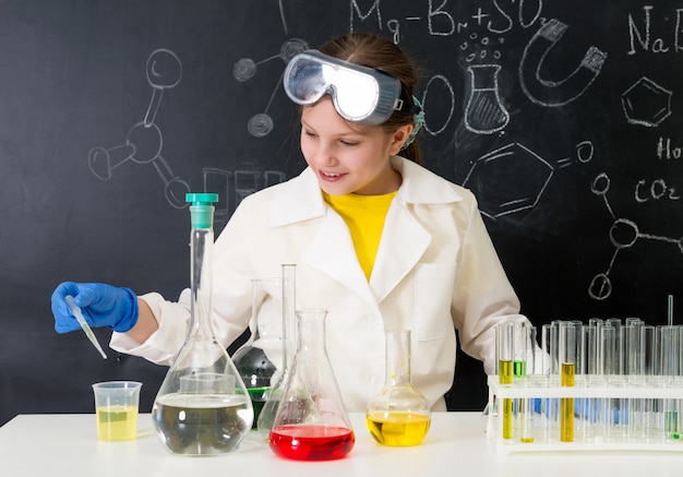 Little kid on chemistry lesson in lab