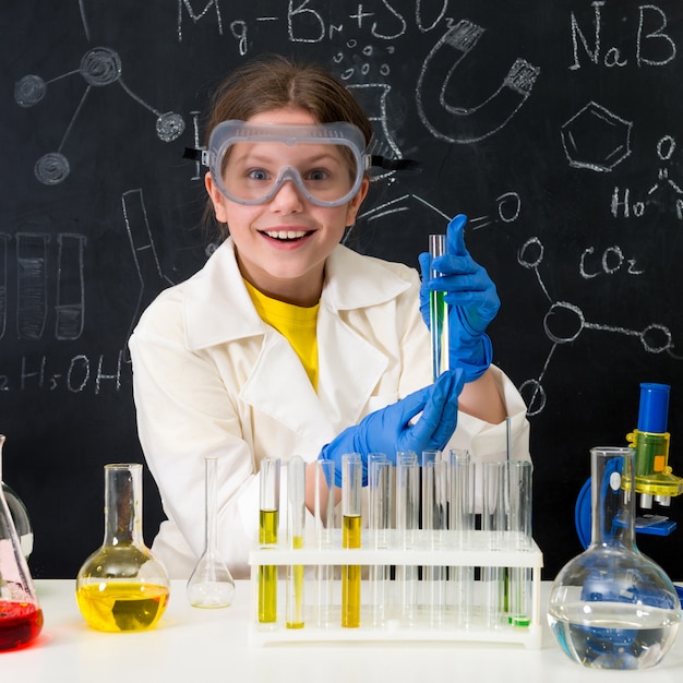 Little kid on chemistry lesson in lab