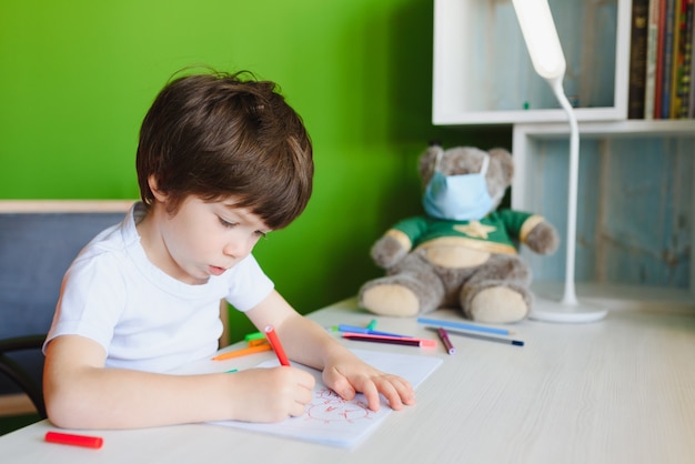 Little kid drawing a coronavirus