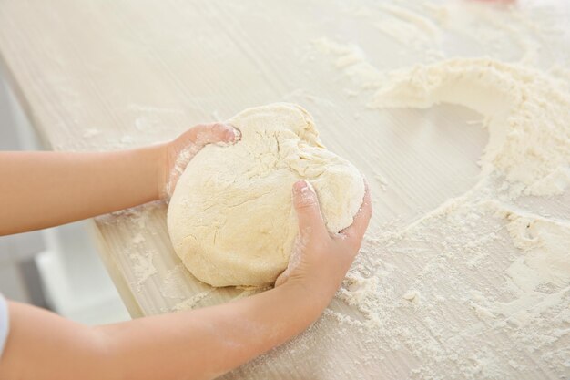 Little kid making biscuits on table