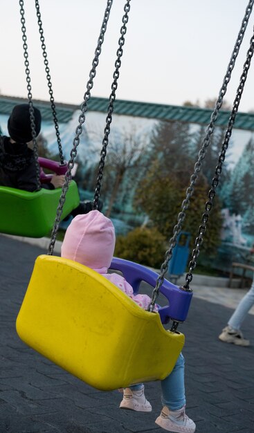 Little kid riding a swing