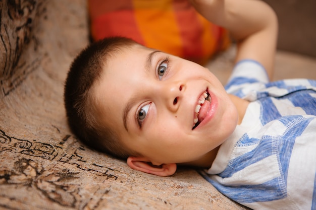 little kid with cerebral palsy has musculoskeletal therapy by doing exercises in body fixing