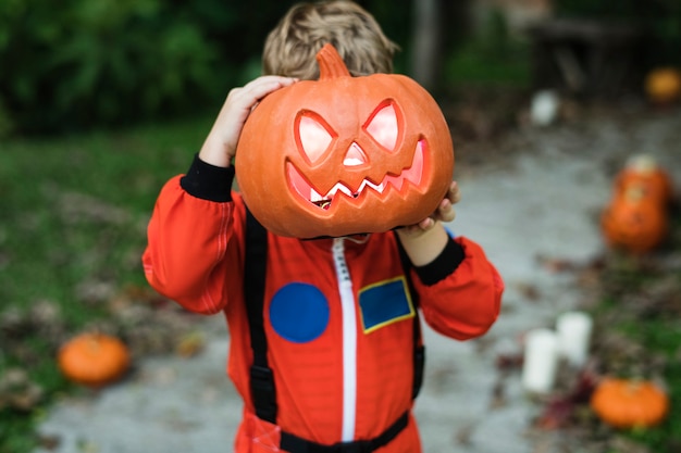 Little kid with Halloween pumpkin