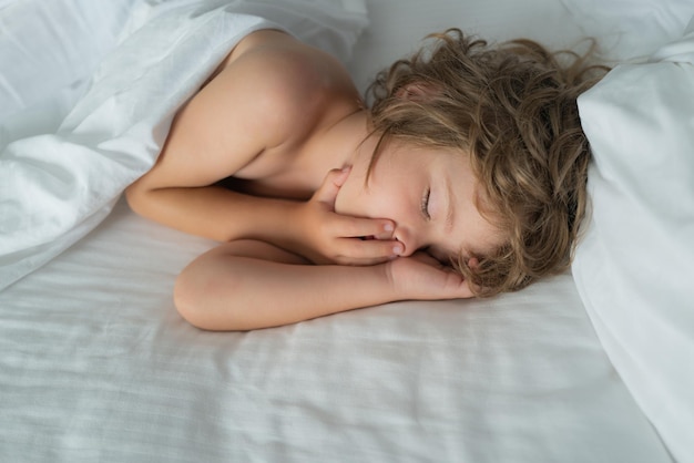 Little kids boy sleeping on the bed Kid sleep in bed