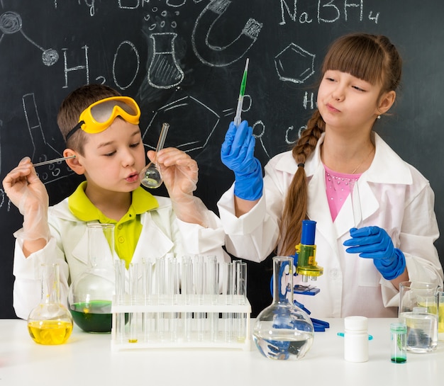 Little kids on chemistry lesson in lab