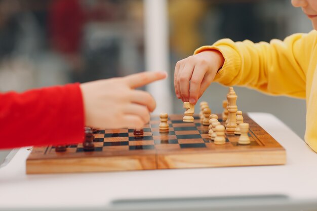 Little kids playing chess at kinder garten or elementary school