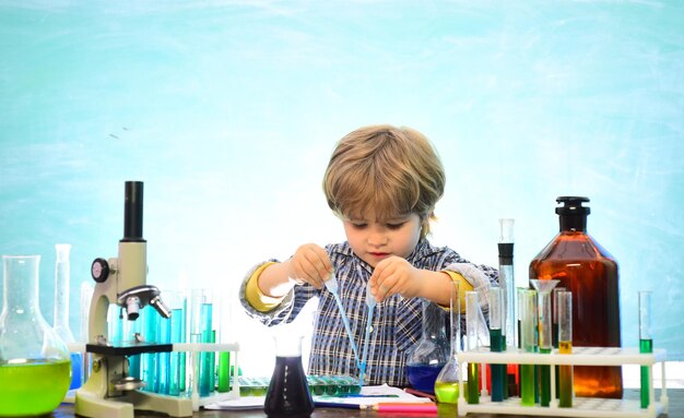 Little kids scientist earning chemistry in school lab Knowledge day School chemistry lessons First g