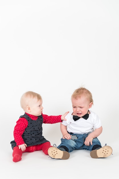 Little kids sitting on the floor