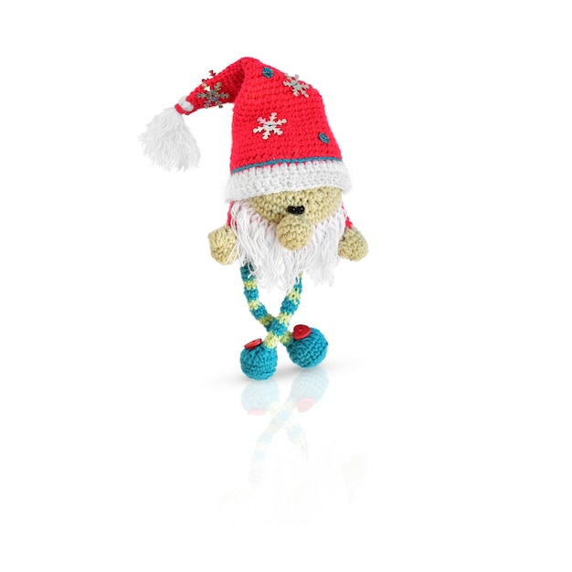 Little knitted gnome in red santa hat isolated on white background. Clipart.