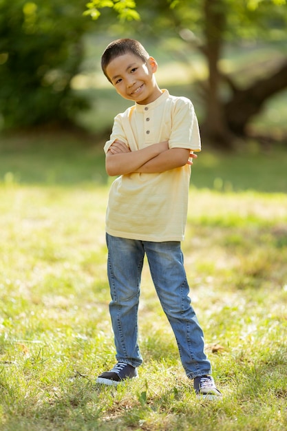 Little Korean boy standing in the park