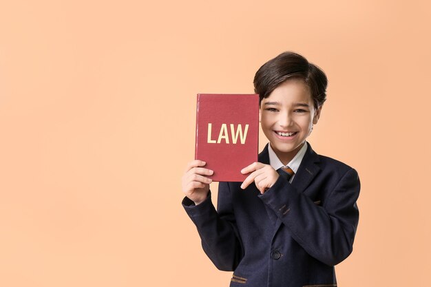 Little lawyer with book on orange