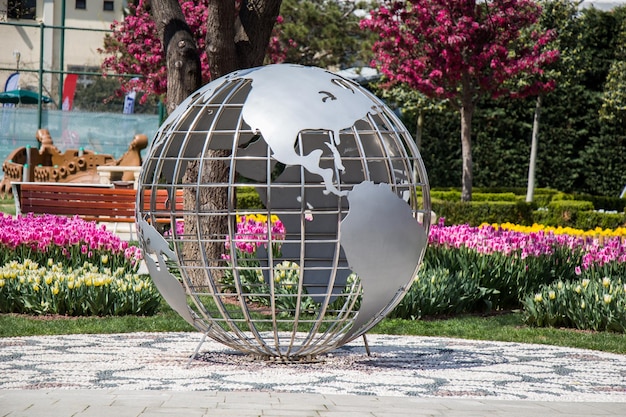 Little model globe made of metal in garden