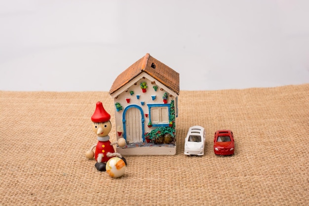 Little model house with cars and pinocchio