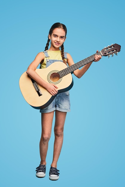 Little musician with acoustic guitar