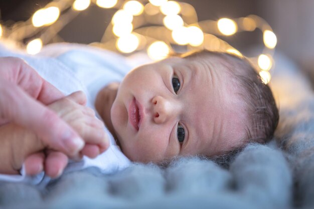 little new born child lying down on knitted cover.