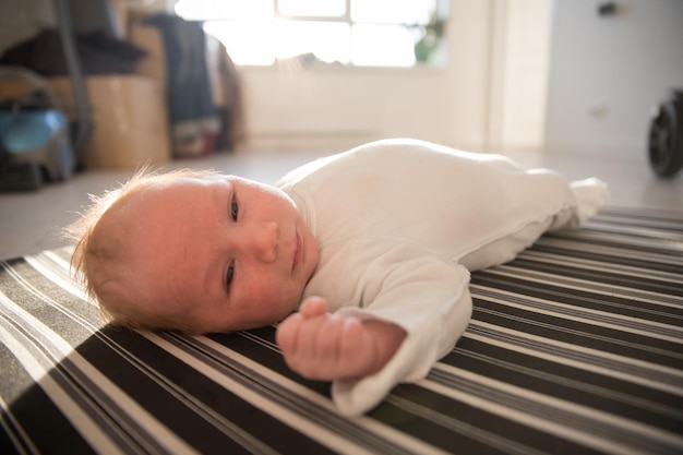 A little newborn baby lying on his back