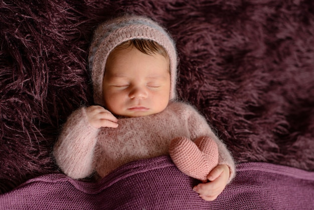 Little newborn sleeping in a comfy bed