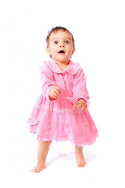 Маленькая годовалая девочка в розовом платье